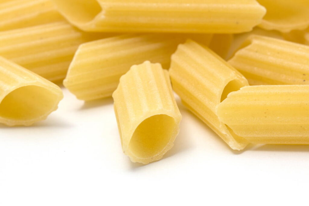 yellow pasta on a white surface - can you compost pasta?