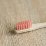 Eco-friendly bamboo toothbrush on a table. Zero-waste. Biodegradable toothbrush.