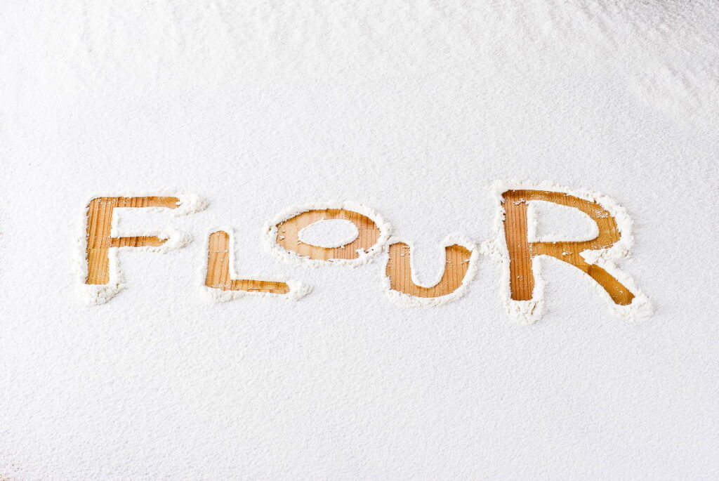 Flour background with word flour - can you compost flour?
