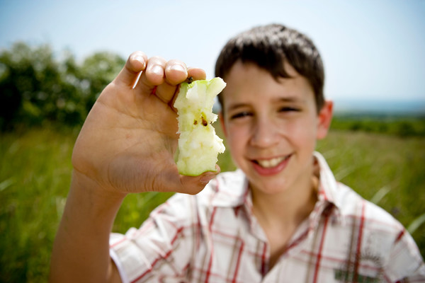 Boy holding apple core