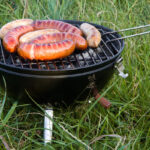 charcoal barbecue grill with sausages cooking