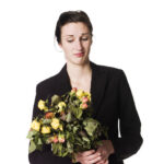 woman holding dead flowers